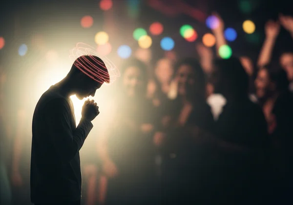 Person feeling overwhelmed and isolated in a social setting